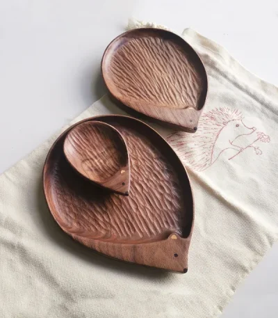 A charming walnut wood plate shaped like a hedgehog