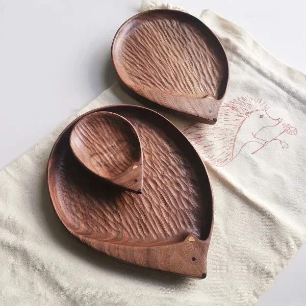 A charming walnut wood plate shaped like a hedgehog