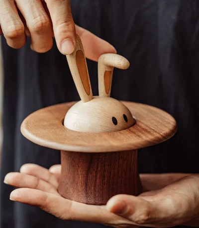 A whimsical wooden music box featuring a magician rabbit design