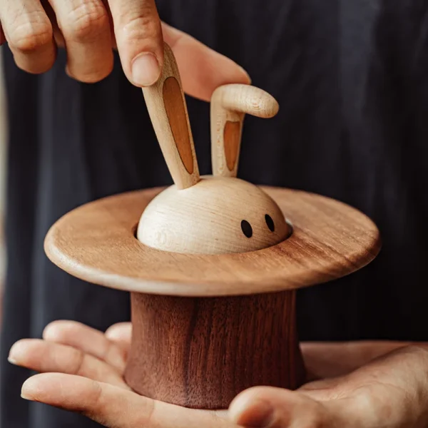 A whimsical wooden music box featuring a magician rabbit design