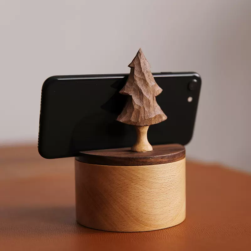 A wooden phone stand box with a cedar tree carving design