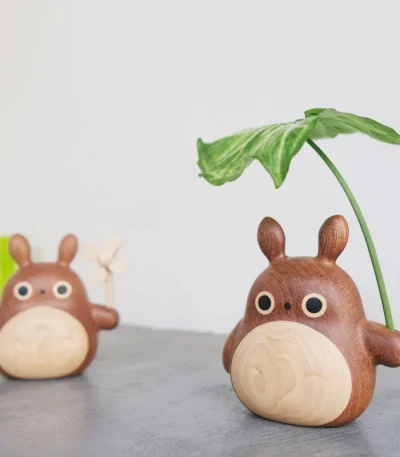 Wooden Totoro figurine with a leaf, perfect for desk or car decoration