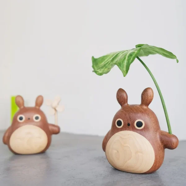 Wooden Totoro figurine with a leaf, perfect for desk or car decoration