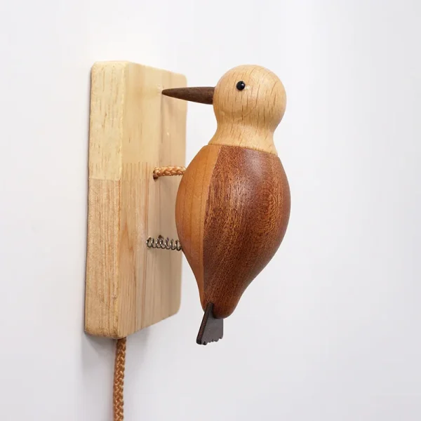 A charming wooden woodpecker doorbell with a color-blocked style