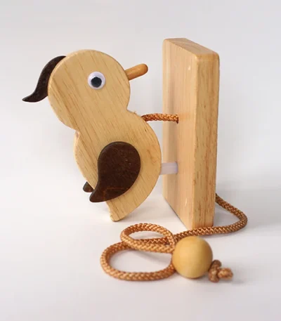 A simple and charming wooden woodpecker doorbell