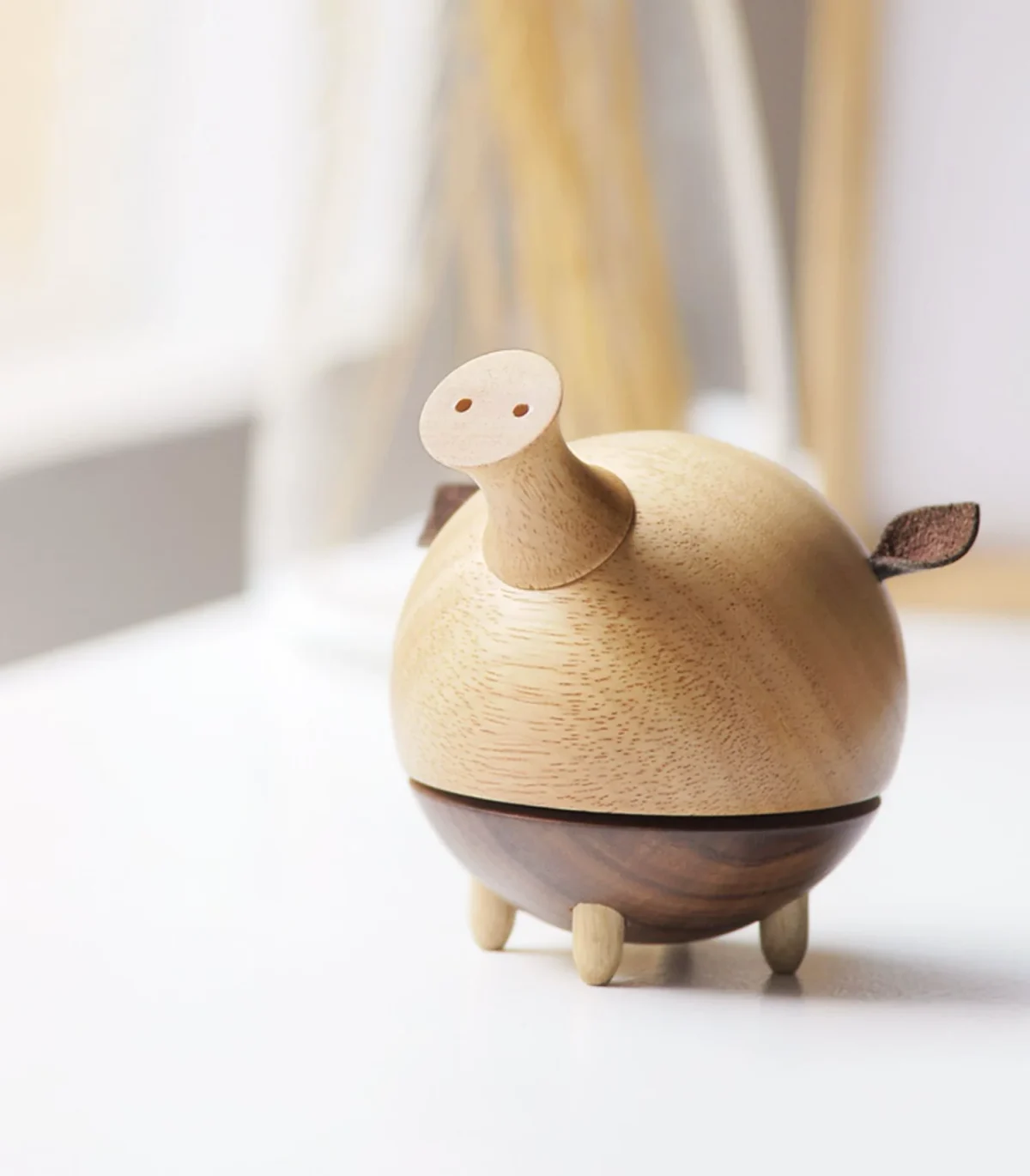 pig-shaped music box crafted from a combination of rubber wood and ebony