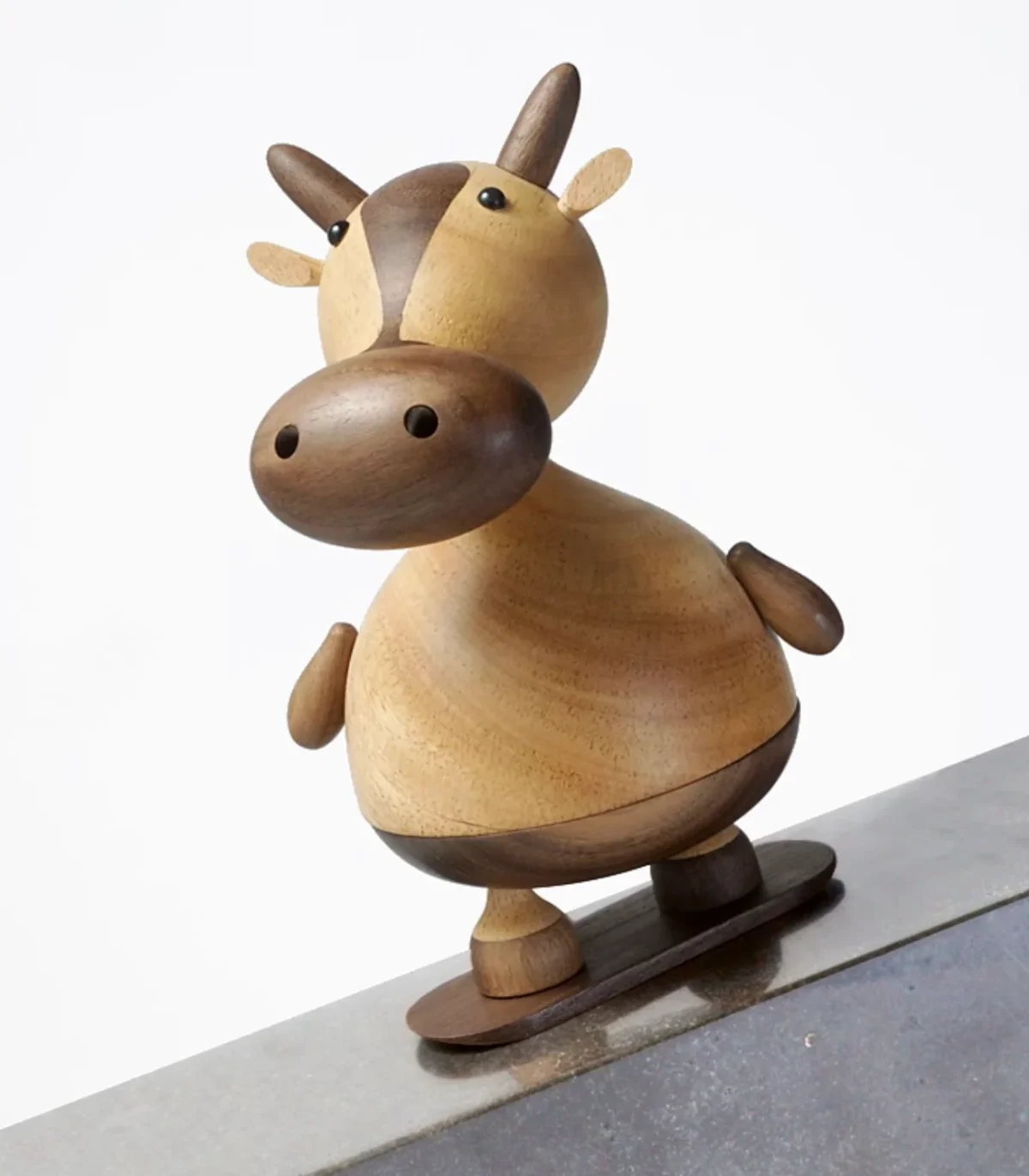 A playful music box featuring a skateboarding cow design, perfect for girls