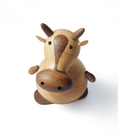 A playful wooden music box featuring a skateboarding cow design, perfect for kids