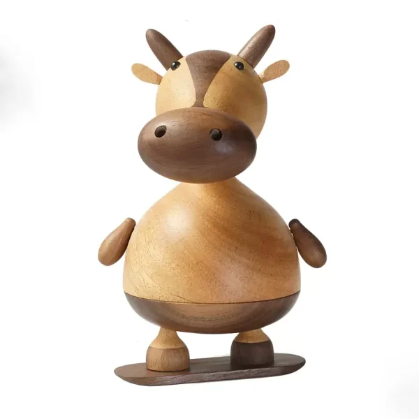 A whimsical wooden music box featuring a cow on a skateboard