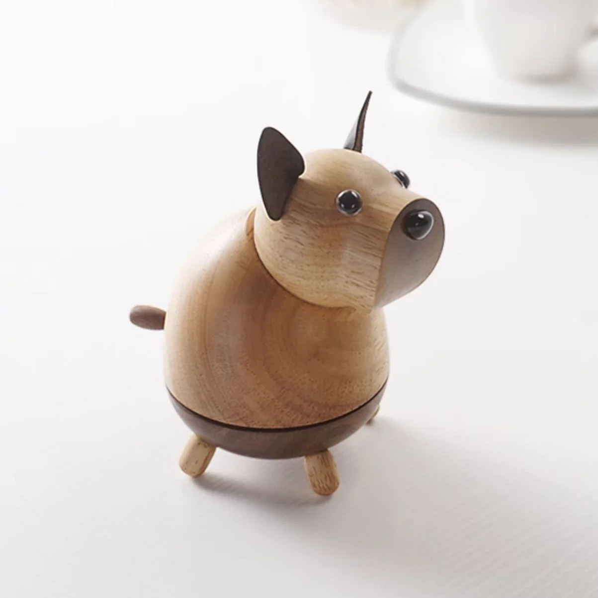 A side view of the charming wooden hugging dog music box, showcasing its detailed craftsmanship