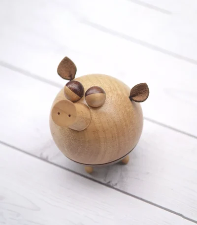 A delightful wooden pig-shaped music box, perfect as a gift for children