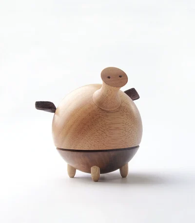 A charming wooden music box featuring a whimsical pig design