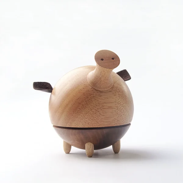 A charming wooden music box featuring a whimsical pig design