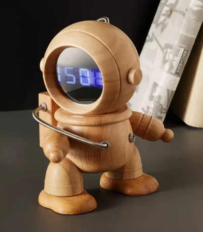 A modern timekeeping device combining space-age aesthetics with digital precision in a charming wooden astronaut design