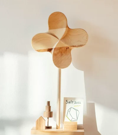 A large wooden pinwheel, perfect for adding a playful and charming touch to your outdoor space