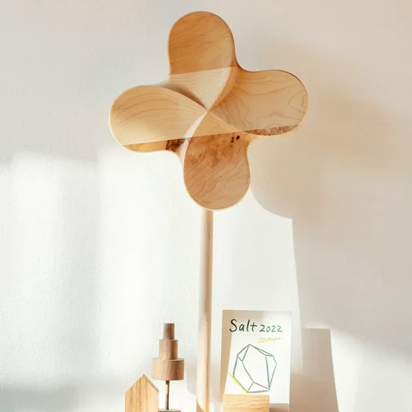 A large wooden pinwheel, perfect for adding a playful and charming touch to your outdoor space