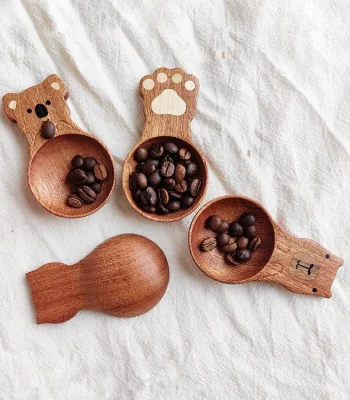 A charming wooden coffee measuring spoon with a cute cat design