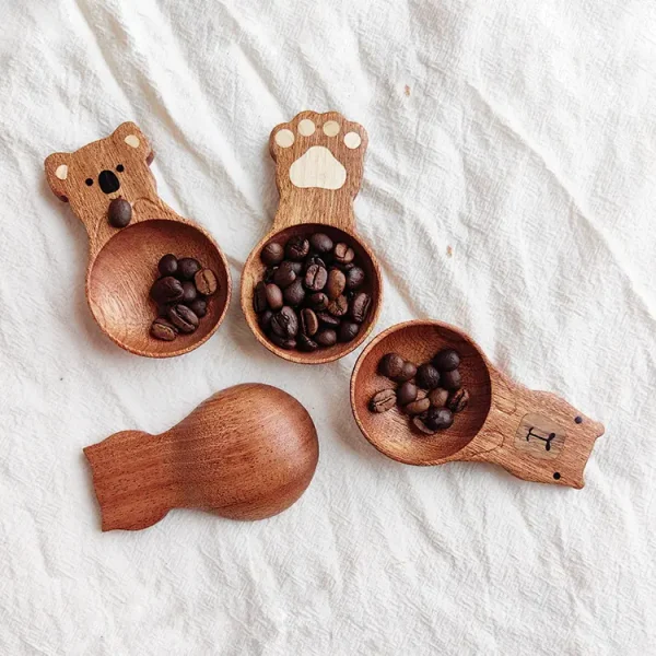 A charming wooden coffee measuring spoon with a cute cat design