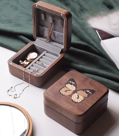 A compact butterfly design jewelry box in walnut wood, ideal for neatly storing necklaces