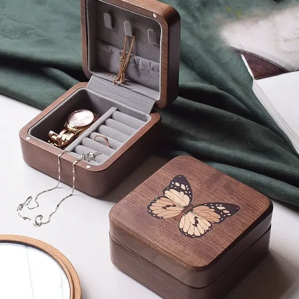 A compact butterfly design jewelry box in walnut wood, ideal for neatly storing necklaces