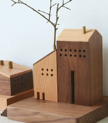 Charming handmade miniature wooden house with flower arrangement for creative home decor