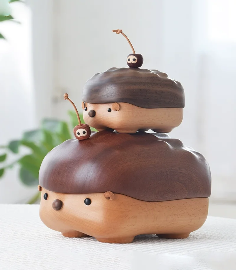 Two hedgehog-shaped wooden storage boxes in different sizes, showcasing walnut and ebony wood options