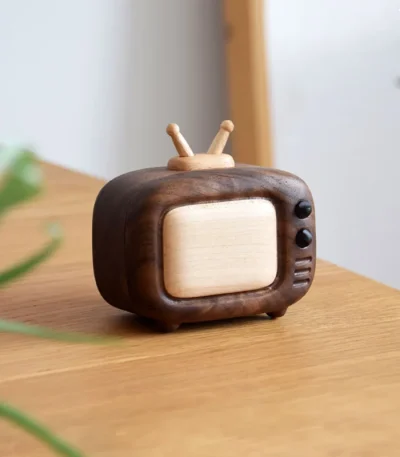 A handcrafted walnut wood mini TV-shaped toothpick holder, perfect as a stylish decor piece for your table