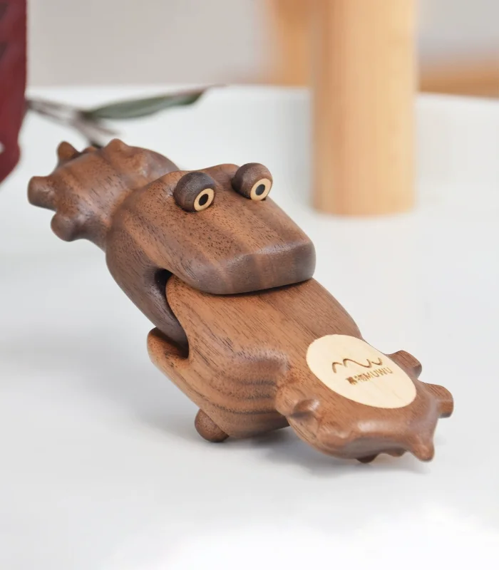 A creatively designed crocodile-shaped fridge magnet crafted from solid walnut wood with hidden magnets, perfect for home decor