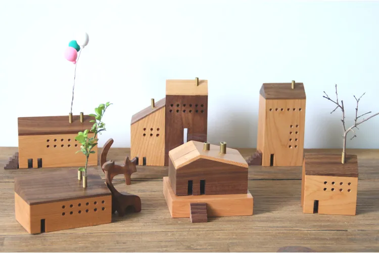 Adorable wooden toy house featuring colorful floral arrangements, ideal for gift-giving