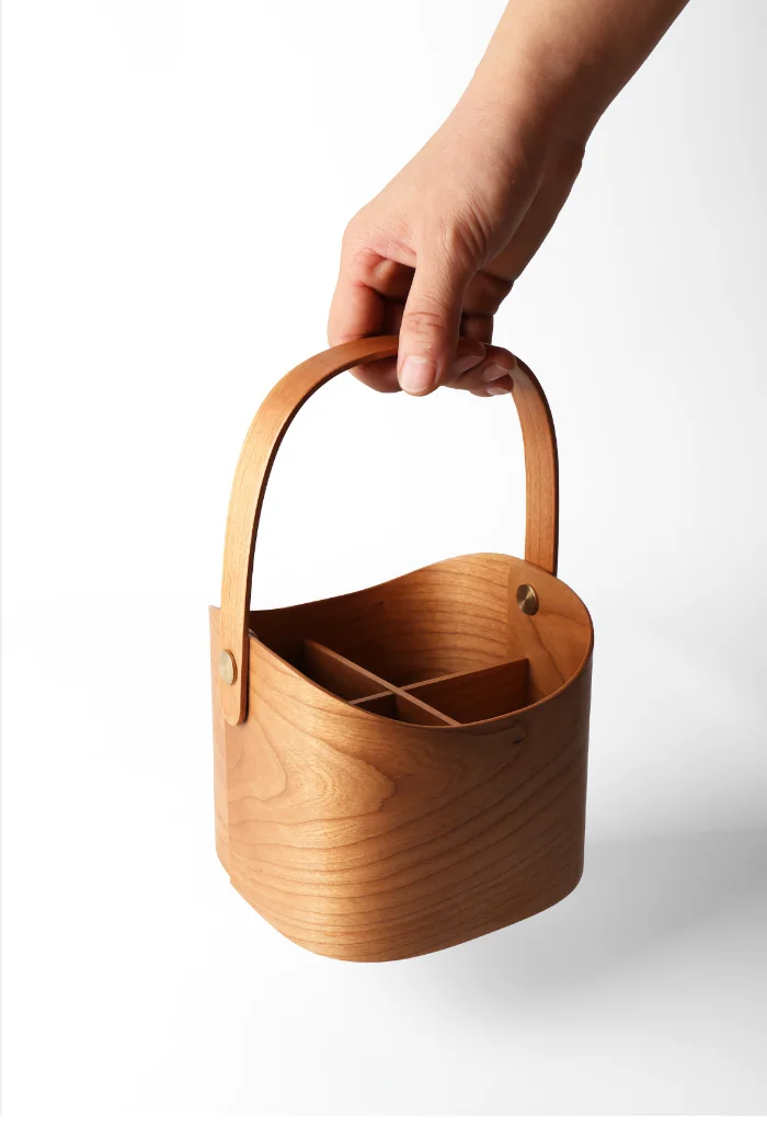 Beautiful wooden basket designed for storing cosmetics, featuring a smooth curved handle