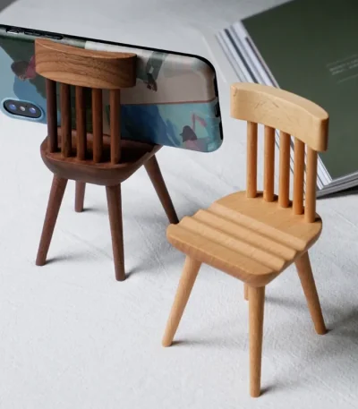 Adorable chair-shaped wooden phone holder, perfect for desk decoration and organizing your phone