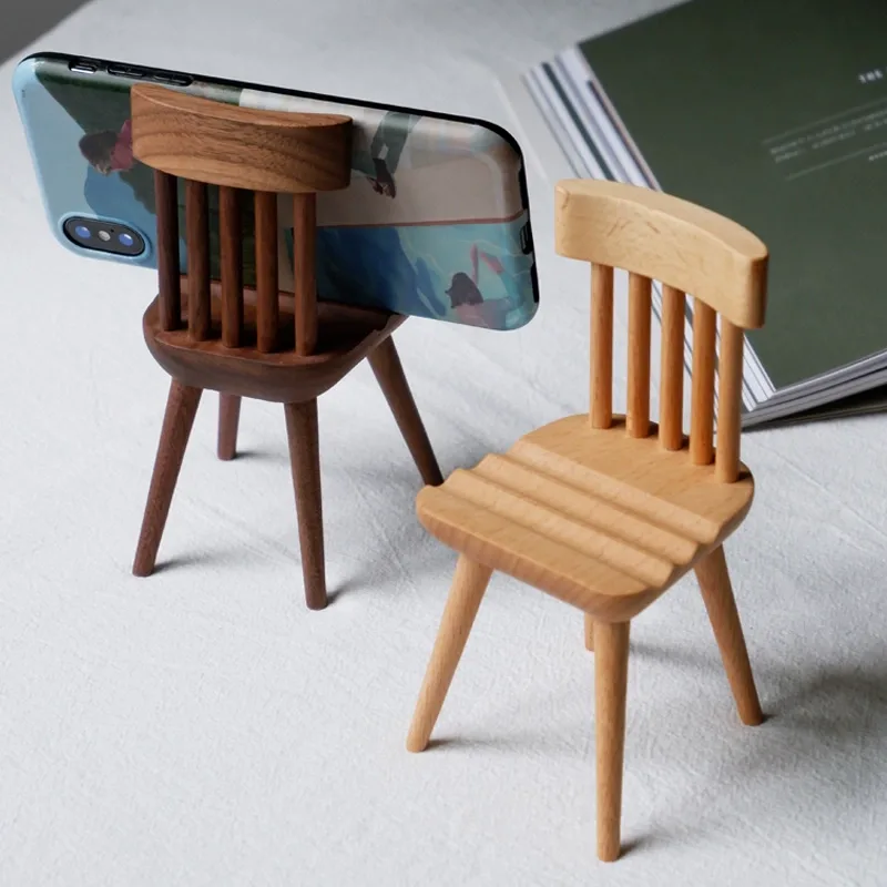 Adorable chair-shaped wooden phone holder, perfect for desk decoration and organizing your phone