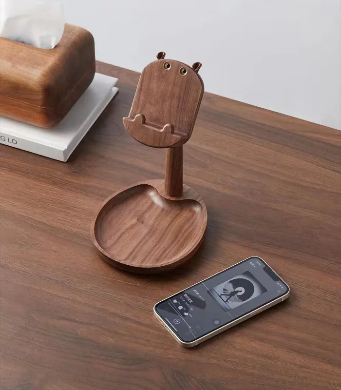 A walnut wood phone stand with a built-in storage plate, ideal for home decor