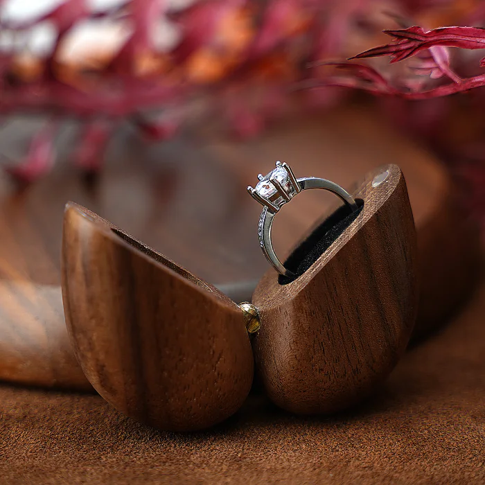 A beautifully crafted wooden wedding ring box with a love theme