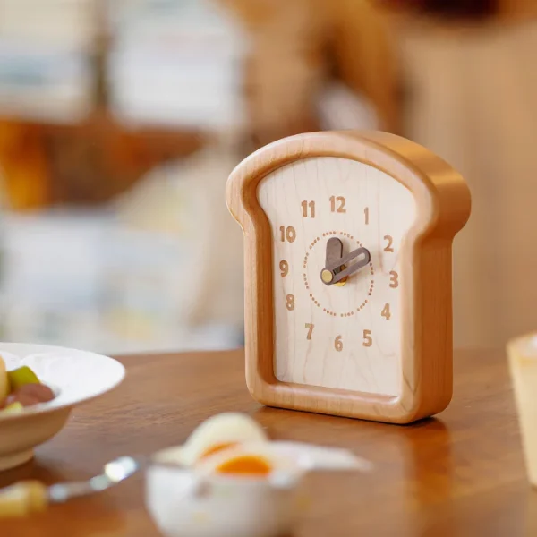 Toast-shaped wooden clock made from cherry and walnut wood, ideal for wall or table decor