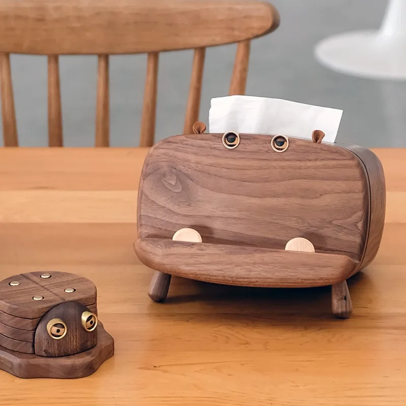 "A set of wooden decor items including a tissue box and a beetle coaster"