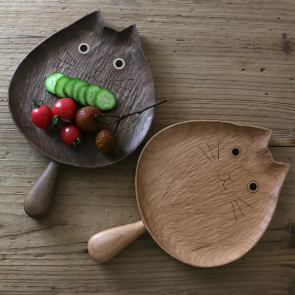 Charming cat-shaped wooden plates with handles, perfect for serving snacks and fruits