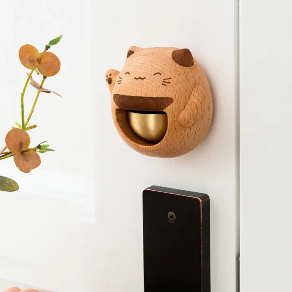 A charming wooden doorbell featuring a lucky cat design