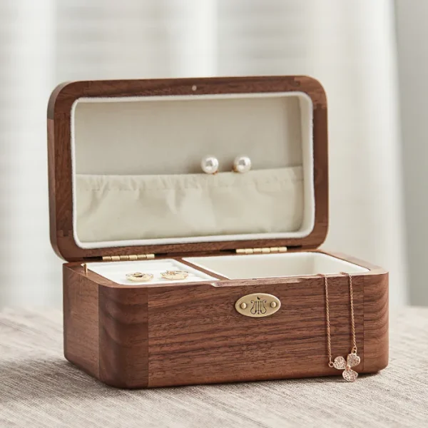 Elegant wooden jewelry box featuring a built-in music box, ideal for storing rings, earrings, and necklaces