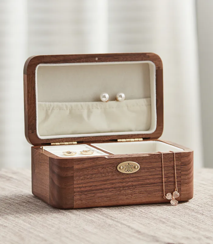 Elegant wooden jewelry box featuring a built-in music box, ideal for storing rings, earrings, and necklaces