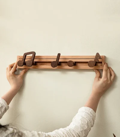 Creative coat rack with music note-shaped hooks, adding a fun and functional touch to your home