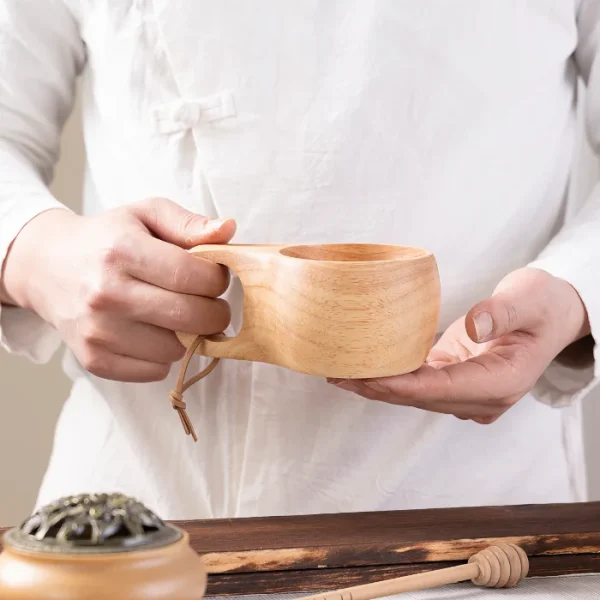 A durable and stylish wooden kuksa cup featuring a large-hole handle for a comfortable grip