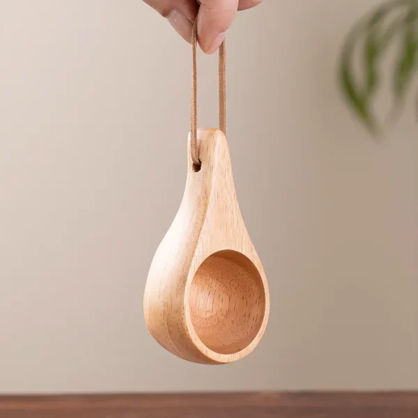 Compact and eco-friendly wooden cup and spoon, perfect for tea, coffee, or small servings