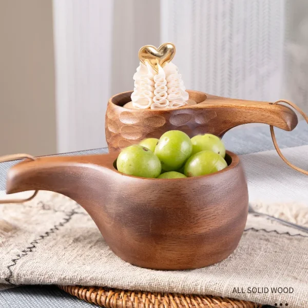 A solid wood kuksa cup featuring a sturdy handle, perfect for enjoying coffee, tea, or soup